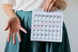 Missed period and marking on calendar. Unwanted pregnancy, woman's health and delay in menstruation. Period late