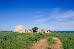 Countryside with trullo huts along the coast of Polignano a Mare. Apulia, Italy