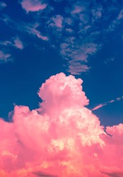 pink red clouds in dim blue sky with orange light