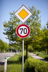 Speed limit road sign of 70 kilometres per hour on the side of a rural road