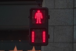 Close up of red Japanese pedestrian traffic light to warn pedestrian that it's not safe to cross the street.