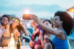 Happy friends taking selfie with smartphone at beach party outdoor - Young people having fun at kiosk bar drinking champagne - Soft focus on mobile cell phone - Youth lifestyle and vacation concept