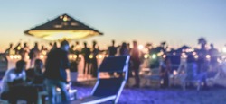 Blurred people having sunset beach party in summer vacation - Defocused image - Concept of nightlife with cocktails and music entertainment