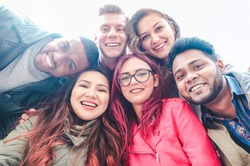 Happy friends from diverse cultures and races taking selfie - Students having fun with technology trends at erasmus university - Youth, tech and friendship concept  - Main focus on bottom girls