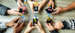 Group of millennial friends using mobile phones - Young people addiction to technology trends following and chatting with emoji on smartphones - Tech and millennial concept - Focus on bottom hands