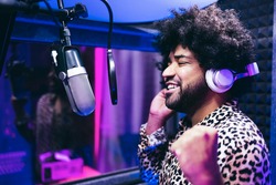 African american singer recording new music album inside boutique studio - Soft focus on man face