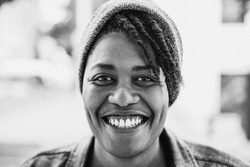 Happy african american woman smiling on camera outdoor - Focus on face - Black and white editing