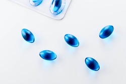 Blue Gel Painkiller Capsules on white background