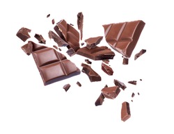 Chocolate broken into pieces in the air on a white background