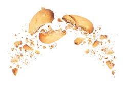 Biscuits broken into two halves with falling crumbs down, isolated on white background