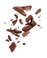 Pieces of dark chocolate falling close up on a white background