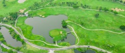 Aerial view of green grass and trees on a golf field, fairway and putting green top view, Bangkok Thailand. bird view over Golf course in the tropical area.