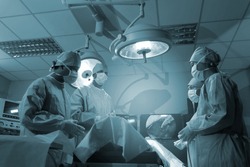 Operating room Doctor or Surgeon, Medical Team Performing Surgical Operation in Modern Operating Room.