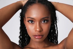 Close-up of African American woman poses indoor. Body and skin care. Isolated.