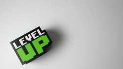 Word: ''Level up'' cube with a with background and space for text