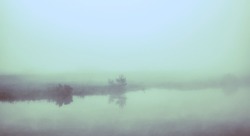 Morning mist on a lake. Infrared filter.