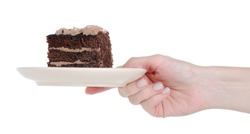 Piece of chocolate cake on plate in hand on white background isolation