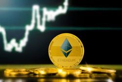 ETHEREUM (ETH) cryptocurrency; gold ethereum coin on the background of the chart