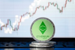 ETHEREUM classic (ETC) cryptocurrency; physical concept ethereum classic coin on the background of the chart