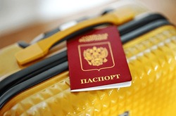 Russian Federation passport on travel suitcase.