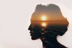 Psychology concept. Sunrise and dreamer woman silhouette.