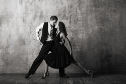 Dancers in black dress dancing tango black and white photo