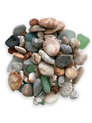 Multi colored stones turned by the sea with water on a white background