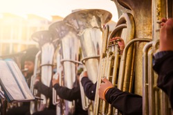 Musician playing tuba in street orchestra / cinematic tone / Made from light photo graphic / soft focus