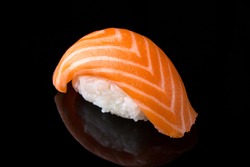 Delicious Sushi Nigiri with Salmon (Sake) on black background. Traditional Japanese cuisine