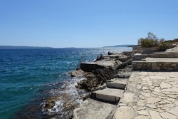 Stepped rocky beach near Trogir in Croatia