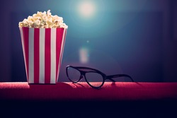 pop corn and 3d glasses on armchair cinema