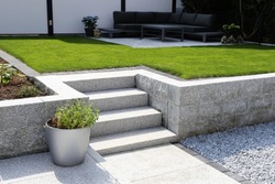 Neat and tidy garden with granite wall and solid block steps