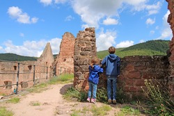 Boy and girl on a castle ruin in the Palatinate forest (Germany)