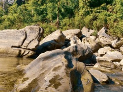 High angle of wonderful scenery of clear river flowing among huge boulders in rocky mountainous at Tindu. Bandarban, Bangladesh