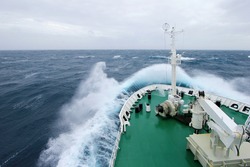 Ship's Bow diving into a big splashing wave, antarctic ocean, Antarctica