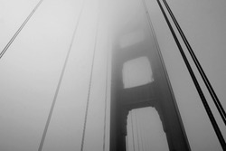 Golden Gate Bridge tower in black and white with fog rolling, San Francisco, USA