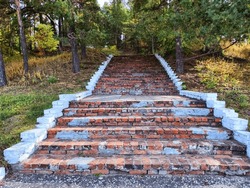 Red brick stairs. Old vintage texture stairway. Grey Grunge blocks stairs in park. Background, location