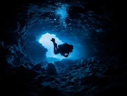 diver hovering inside a cave
