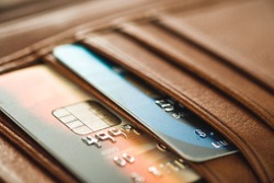 Credit cards in brown wallet in shallow focus