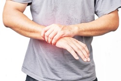Asian male arms holding his painful wrist caused by exercise. Asian man hand holding his pain wrist isolated on background                        