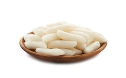 Tteok or Korean Rice Cakes in wooden plate isolated on white background. pile of Tteok or Korean Rice Cakes in wooden dish isolated on white background