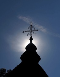 The cross on the orthodox church tower in sunlight