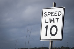united states speed limit sign 10 mph against cloudy sky
