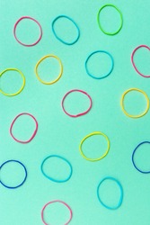 Thin multicolored elastic bands on plain background. 