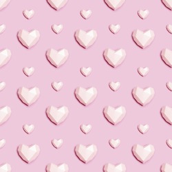 Seamless pattern with pink polygonal paper heart on pink background. Wallpaper for Valentines Day. Love concept. Plain colored. Monochrome image. Minimal style.