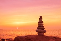 Stones balance on a background of sea sunset. Calm and meditation. Concept of harmony and balance