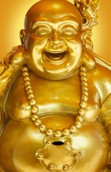 The Golden smiling Buddha or Hotei is the chinese god of happiness, wealth and good luck. Close-up