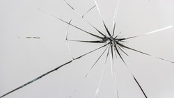 Cracks on the glass on a white background. Broken window.