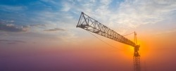 Construction crane on a background of the morning sky. Panorama with space for text. Concept, construction.