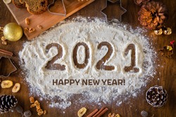 Creative Happy New Year 2021 greeting card for home baker, baking, numbers made out of flour, top view, wish